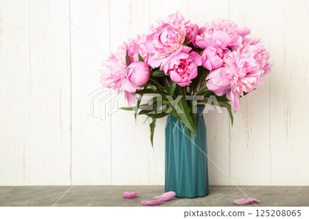 Vase with beautiful peonies on light background 125208065