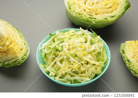 Fresh cut cabbages on plate on grey background 125208091