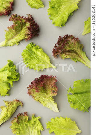 Fresh red lettuce leaves on grey background. Vertical photo 125208143