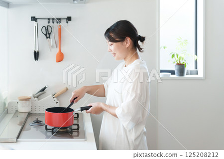 Woman cooking Woman cooking 125208212