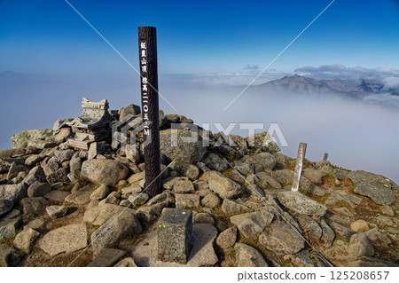 The ridgeline of Mt. Kitamata seen from the summit of Mt. Iide Honzan with the clouds rolling by 125208657
