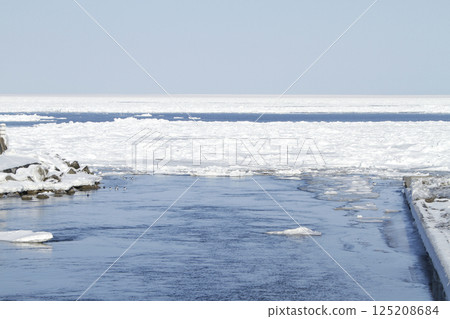 View of drift ice in the Sea of Okhotsk from the window of the Senmo Main Line train. Drift Ice Story Train and Drift Ice Norokko Train 125208684