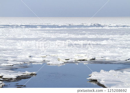 View of drift ice in the Sea of Okhotsk from the window of the Senmo Main Line train. Drift Ice Story Train and Drift Ice Norokko Train View of drift ice in the Sea of Okhotsk from the window of the Senmo Main Line train. Drift Ice Story Train and Drift Ice Norokko Train 125208692