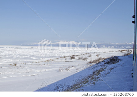 View of drift ice in the Sea of Okhotsk from the window of the Senmo Main Line train. Drift Ice Story Train and Drift Ice Norokko Train View of drift ice in the Sea of Okhotsk from the window of the Senmo Main Line train. Drift Ice Story Train and Drift Ice Norokko Train 125208700