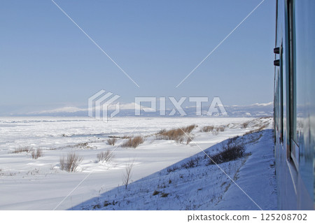 View of drift ice in the Sea of Okhotsk from the window of the Senmo Main Line train. Drift Ice Story Train and Drift Ice Norokko Train 125208702