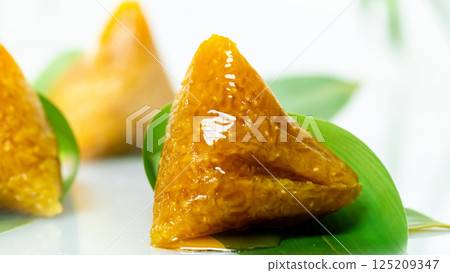 Delicious sweet rice dumplings topped with honey Delicious sweet rice dumplings topped with honey 125209347