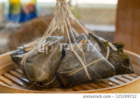 Traditional Asian sticky rice dumplings in bamboo steamer 125209722
