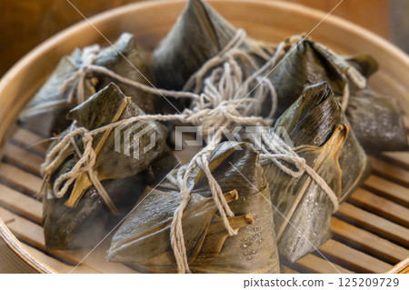 Traditional Asian sticky rice dumplings in bamboo steamer 125209729