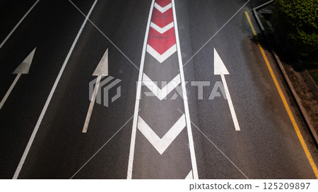 Multiple Highway Lanes with Directional Arrow Markings and Chevron Safety Signage Multiple Highway Lanes with Directional Arrow Markings and Chevron Safety Signage 125209897