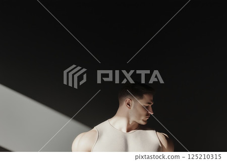 Moody portrait of a man in shadow with dramatic lighting and minimalist aesthetic 125210315