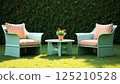 Recycled oil drum garden furniture with striped cushions on green lawn 125210528