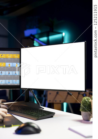 Photographer using advanced photo editing software on isolated screen monitor to make improvement to images quality. Photo editor utilizing specialized photographs retouching application on mockup PC 125211915