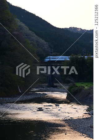 Spacia X crossing the Tobu Nikko Line Yukigawa Bridge at dusk 125212366