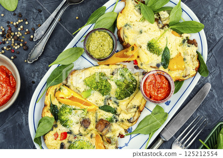 Herb omelet with broccoli. 125212554