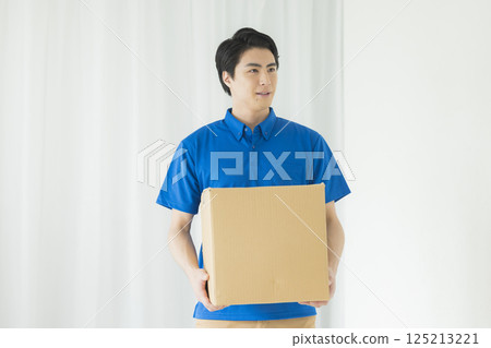 A man with a smile carrying baggage A man with a smile carrying baggage 125213221