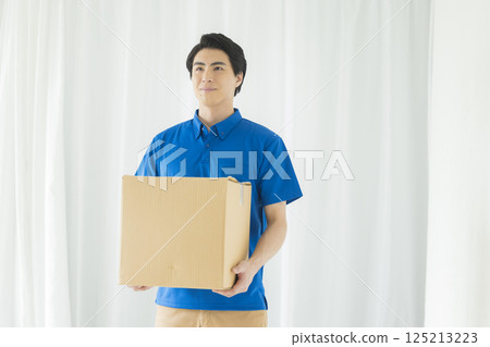 A man with a smile carrying baggage 125213223