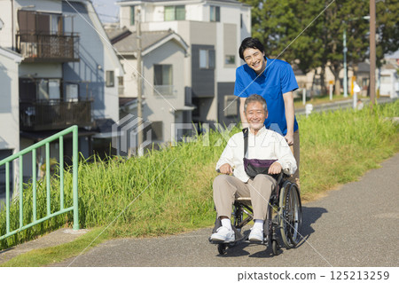 Senior men riding a wheelchair 125213259