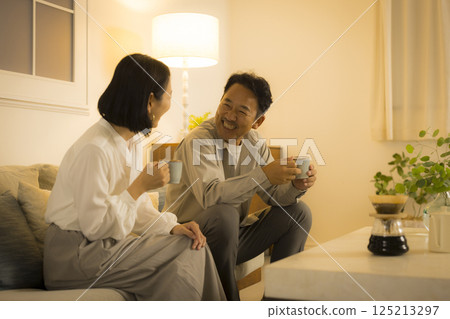 Middle-aged couple in the living room at night 125213297