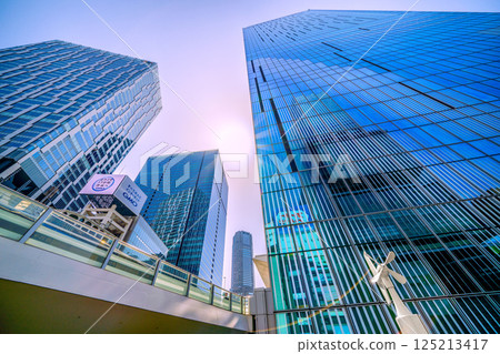 Tokyo cityscape in Japan. Summer-like heat...Shibuya buildings...skyscrapers reflected in window glass. Shibuya, a kaleidoscope city. 125213417