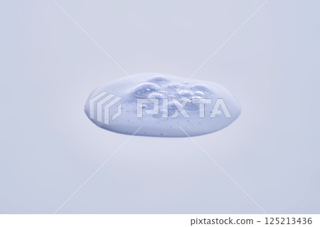 A drop of blue serum with bubbles. A drop of blue serum with bubbles. 125213436