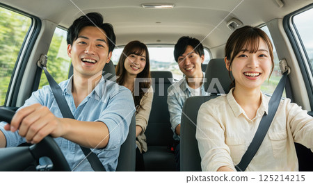 Asian men and women smiling and enjoying a drive Asian men and women smiling and enjoying a drive 125214215