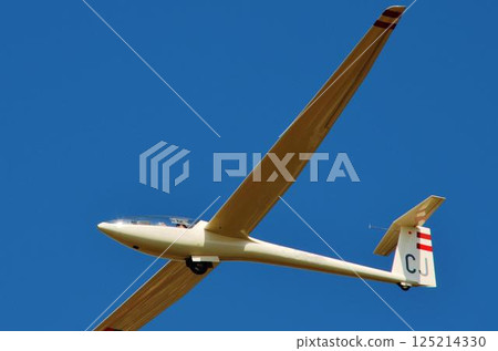 Glider gliding through the blue sky 125214330