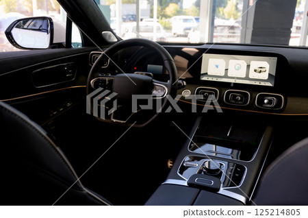Car interior - steering wheel, shift lever and dashboard. Car modern inside. Front view Car interior - steering wheel, shift lever and dashboard. Car modern inside. Front view 125214805
