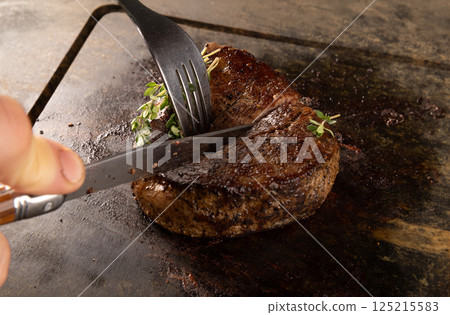 Chef cutting grilled steak Chef cutting grilled steak 125215583