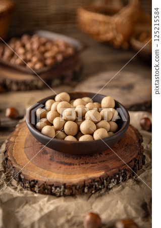 Crunchy roasted hazelnuts coated with white chocolate Crunchy roasted hazelnuts coated with white chocolate 125215584