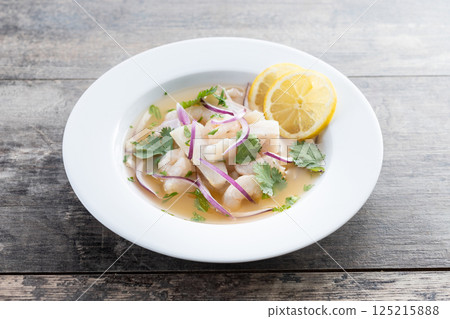Traditional Peruvian ceviche sea bass fillet on wooden table Traditional Peruvian ceviche sea bass fillet on wooden table 125215888