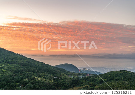 Veil of Light: The Enchanting Sunrise Over Datun Mountain. 125216251