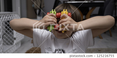 Child with autism playing with lego peaces Child with autism playing with lego peaces 125216755
