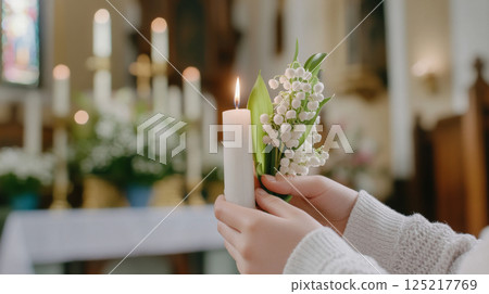 Chrismation symbol with young girls hands holding candle and flowers Chrismation symbol with young girls hands holding candle and flowers 125217769