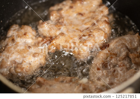 Deep frying sardine meatballs (stock photo) 125217851