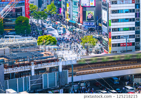Tokyo cityscape in Japan, overlooking the new entrance/exit side of the Hachiko ticket gate at Shibuya Station, Shibuya Scramble Crossing (in the background), the Yamanote Line, etc. Tokyo cityscape in Japan, overlooking the new entrance/exit side of the Hachiko ticket gate at Shibuya Station, Shibuya Scramble Crossing (in the background), the Yamanote Line, etc. 125218215