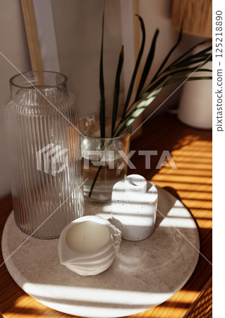 Close-up of the aesthetic details of the home interior. Ceramic tray on a wooden chest of drawers in the bedroom 125218890