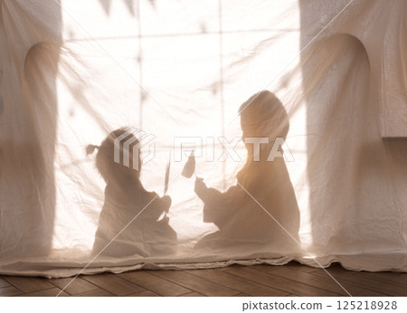 Children paying in the living room. Korean kids staged a shadow theater. Children paying in the living room. Korean kids staged a shadow theater. 125218928