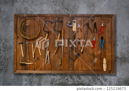 Tools on wall hanging at a carpentry workshop 125219673