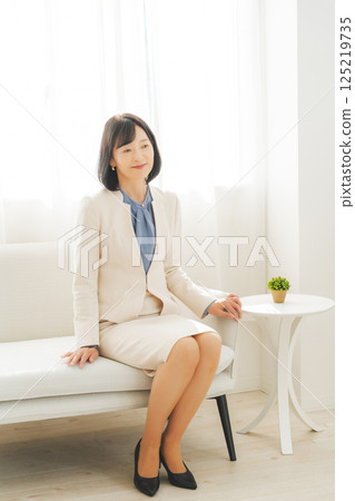 Image of a middle-aged career woman in a white suit Image of a middle-aged career woman in a white suit 125219735