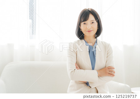 Image of a middle-aged career woman in a white suit Image of a middle-aged career woman in a white suit 125219737