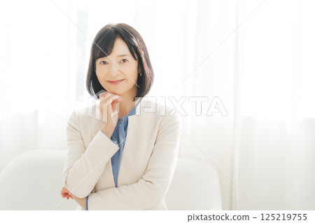 Image of a middle-aged career woman in a white suit Image of a middle-aged career woman in a white suit 125219755