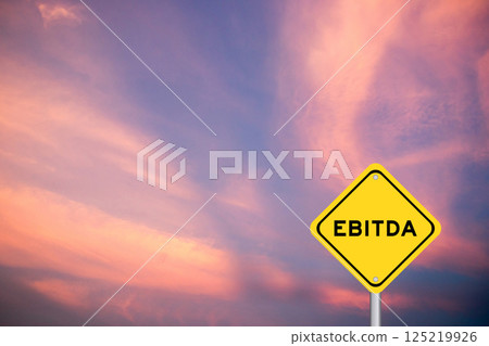 Yellow transportation sign with word EBITDA (abbreviation of earnings before interest, taxes, depreciation and amortization) on violet color sky background Yellow transportation sign with word EBITDA (abbreviation of earnings before interest, taxes, depreciation and amortization) on violet color sky background 125219926