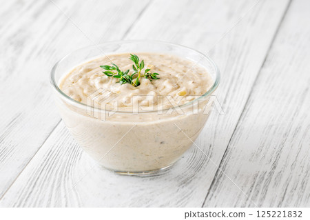Creamy blue cheese sauce garnished with thyme in clear bowl on table Creamy blue cheese sauce garnished with thyme in clear bowl on table 125221832