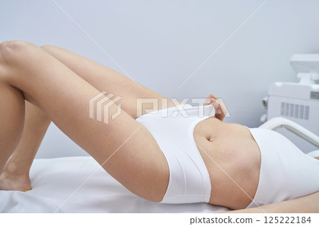 Female receiving laser hair removal treatment in clinic setting Female receiving laser hair removal treatment in clinic setting 125222184