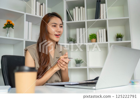 Remote Communication and Engagement. A professional woman participating in a video call with enthusiasm. 125222791