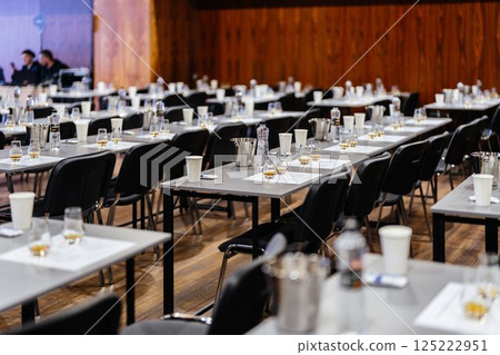Empty tables set for a whisky tasting event in a cozy venue 125222951