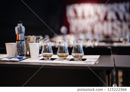 Tasting fine spirits at a distillery event in a modern setting Tasting fine spirits at a distillery event in a modern setting 125222966