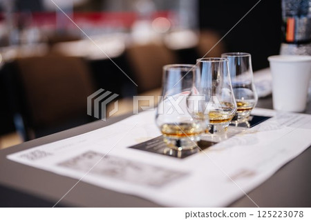 Whisky tasting experience with elegant glasses and notes on the table Whisky tasting experience with elegant glasses and notes on the table 125223078