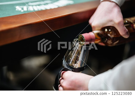 Pouring fine wine at an elegant gathering for an unforgettable evening Pouring fine wine at an elegant gathering for an unforgettable evening 125223080