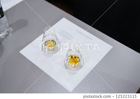Enjoying whiskey tasting during an evening gathering in a cozy setting Enjoying whiskey tasting during an evening gathering in a cozy setting 125223115